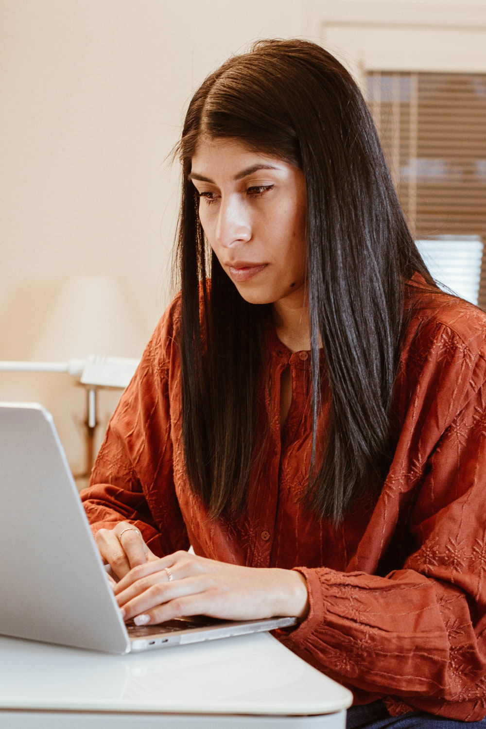 Monica Say, the founder of Code with Nano and the Code-2-Code program, coding on her computer at home.